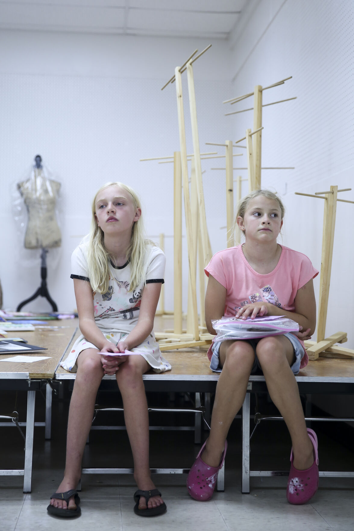 From left, Devyn Serres, 10, and Taya Verplancke, 10, wait on the stage